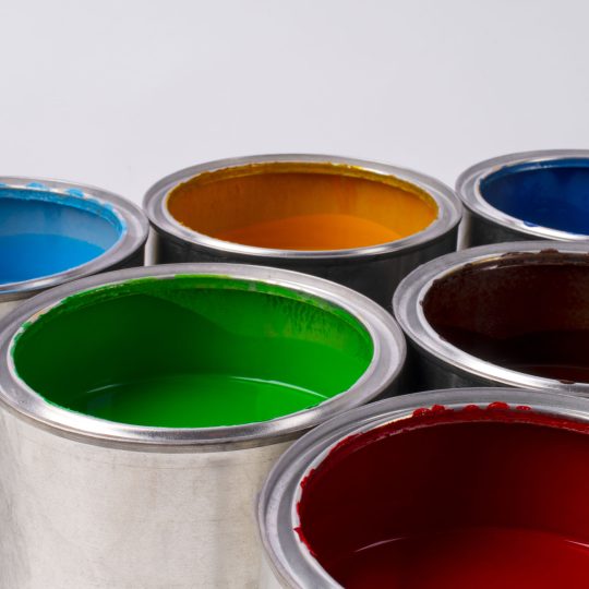 Open cans of colorful paint showcasing different paint options and finishes by Berger Paints.