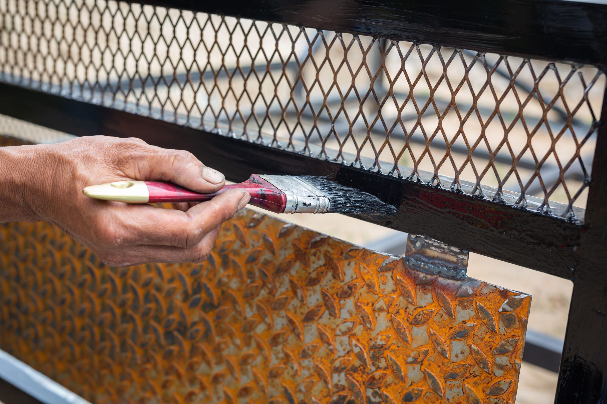 Applying anti-corrosive paint to a metal surface to protect against rust in humid environments by Berger Paints.