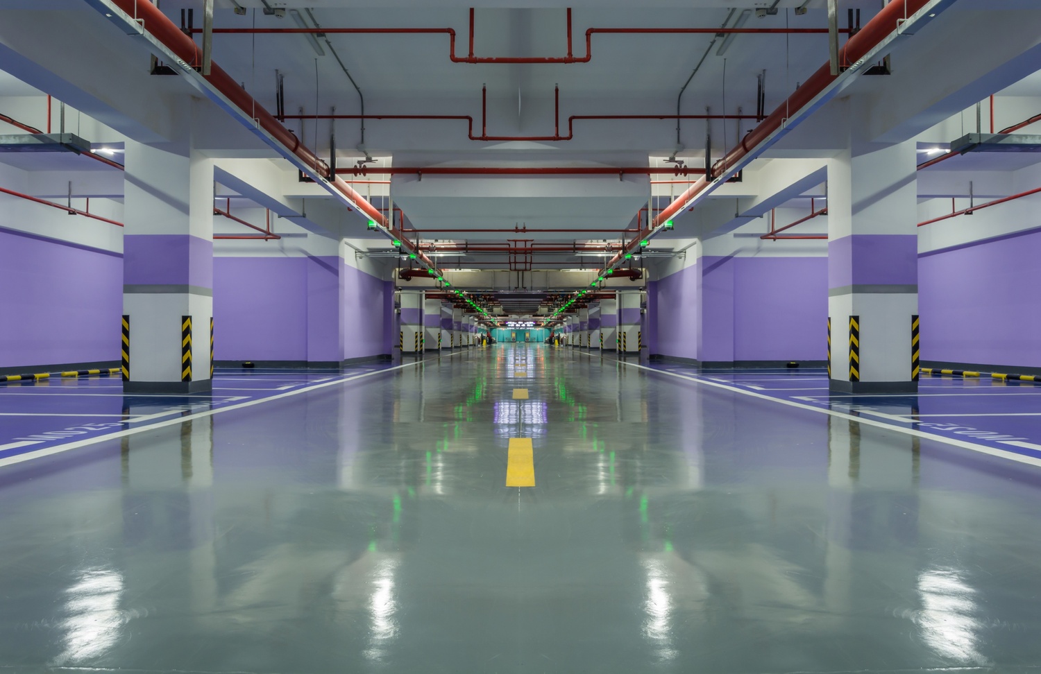 Glossy commercial floor coating in an underground parking area showing durable industrial flooring.