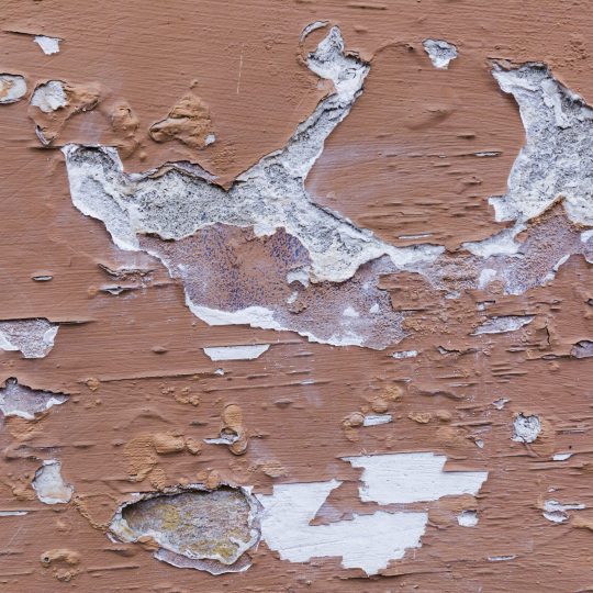 Peeling exterior wall paint damaged by weather and moisture in Singapore climate conditions.