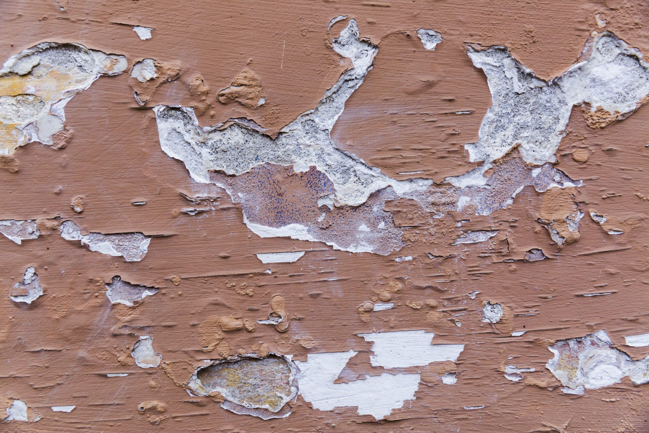 Peeling exterior wall paint damaged by weather and moisture in Singapore climate conditions.