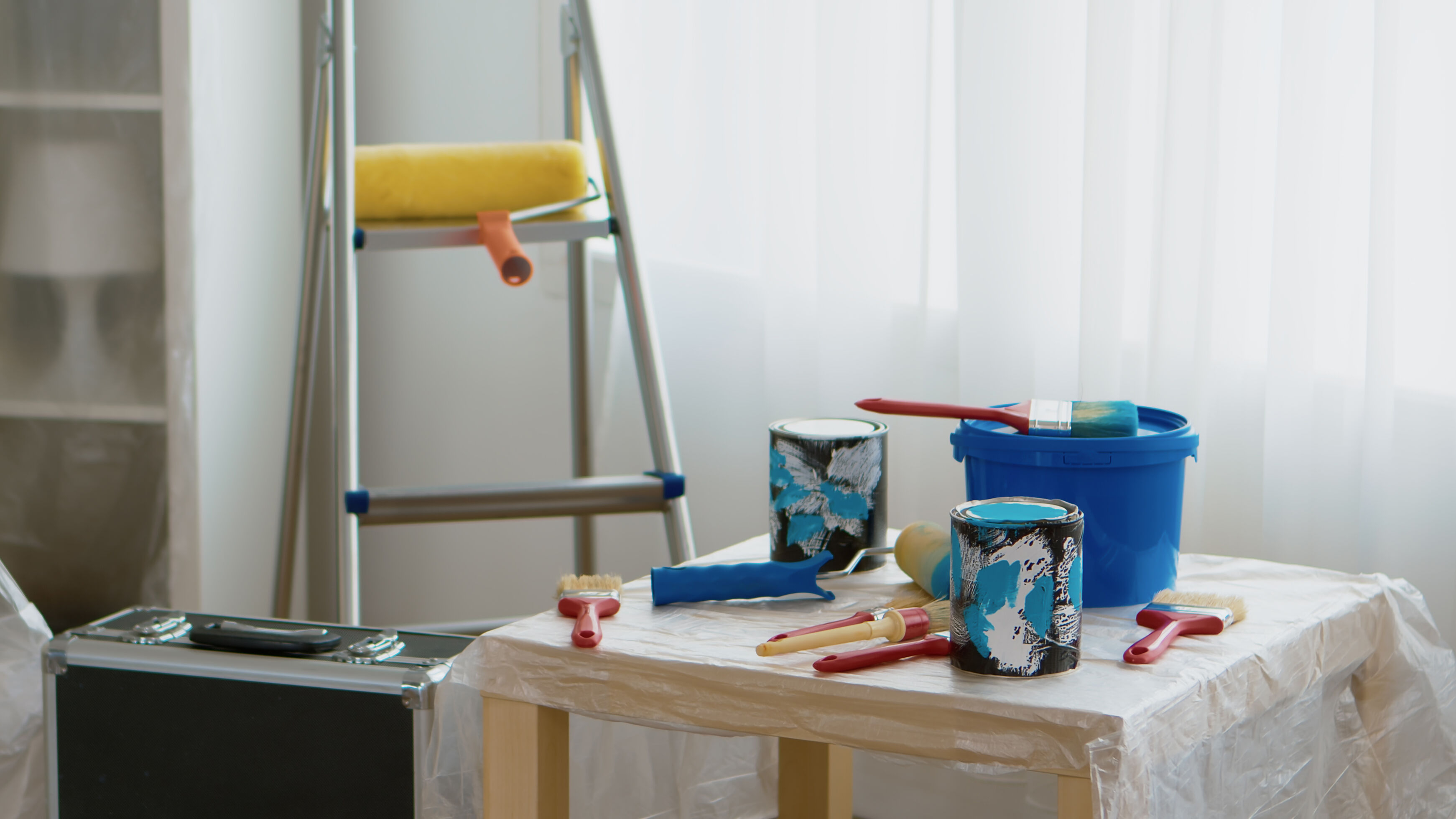 Paint cans, brushes, roller and ladder for refreshing small HDB living rooms, corridors and bedrooms.